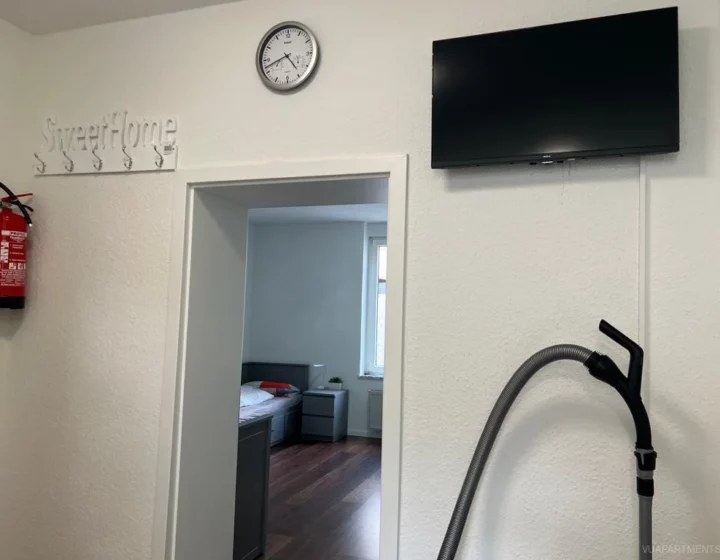 Fernseher über dem Durchgang zum Schlafbereich – Apartment 5 in Bochum
